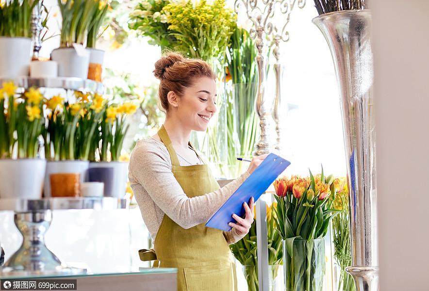 人,销售,零售,商业花卉快乐微笑的花店妇女与剪贴板写作笔记订单花店